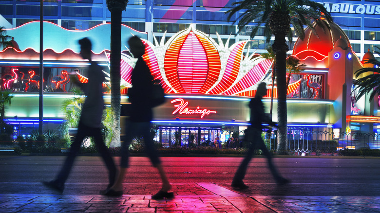 Walking past the lights of the Flamingo casino in Las Vegas