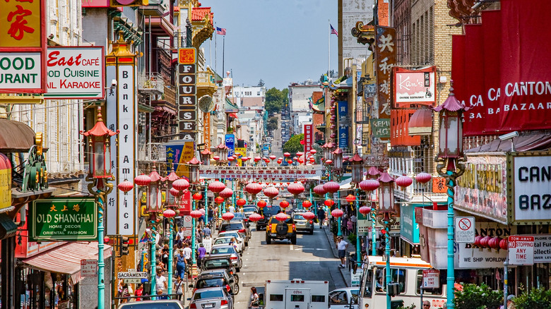 San Francisco's Chinatown with cars, lanterns, and Chinese store signage