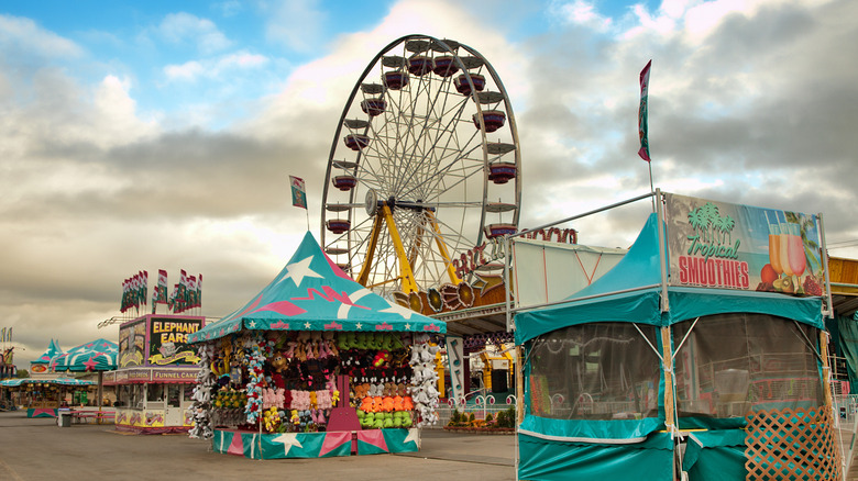 Booths and a Ferris wheel at the Midway of the Great New York State Fair