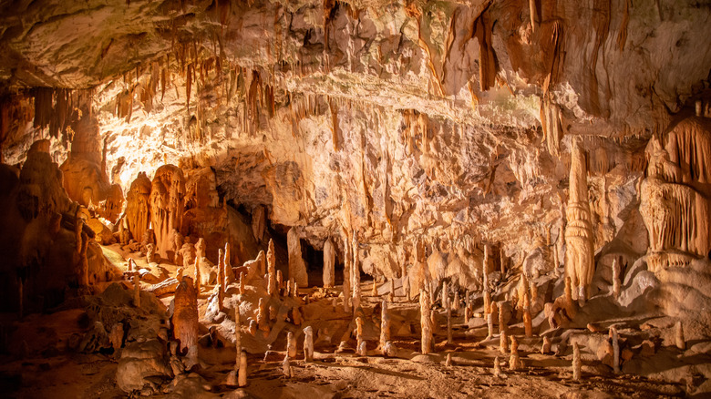 Underground cave lit up to show stalactites and stalagmites