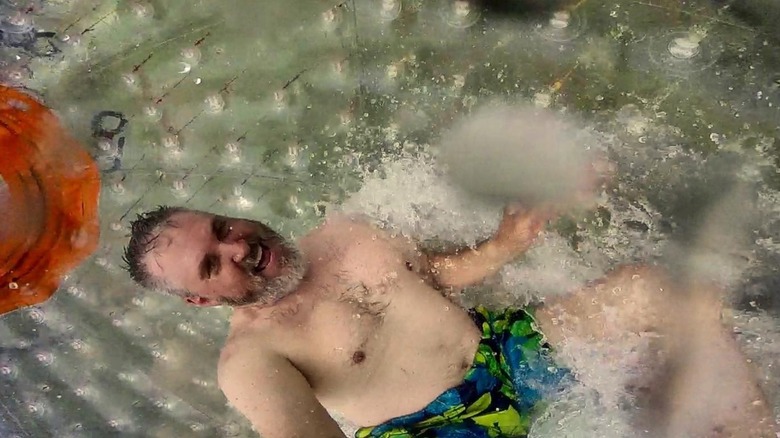 Man splashes around in hydrozorb at Outdoor Gravity Park