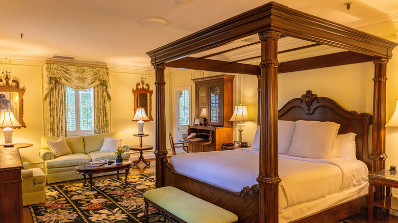 Mr. Gray's Suite, an opulent room with a dark wood 4-poster bed and antique furniture at The Graylyn Estate