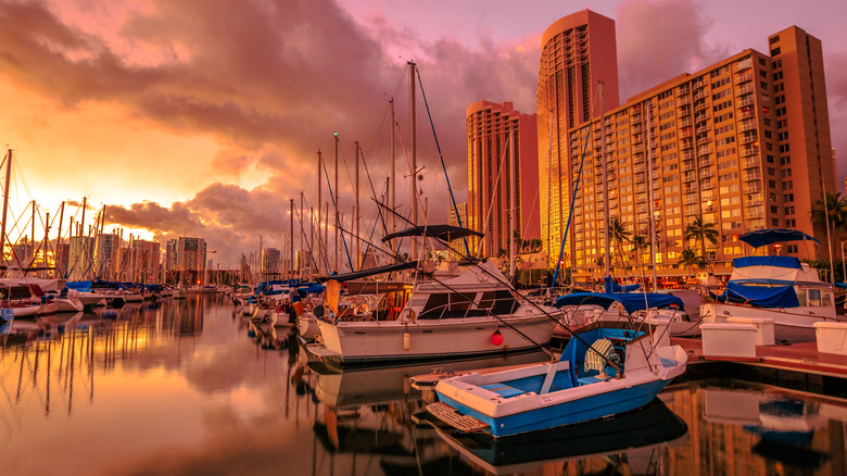 Boats docked in Honolulu harbor at sunset