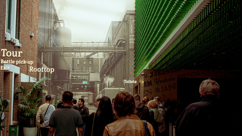 A tour group wanders through the interior of the Heineken Experience beer museum