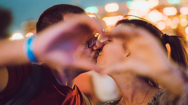 A couple making a heart with their hands