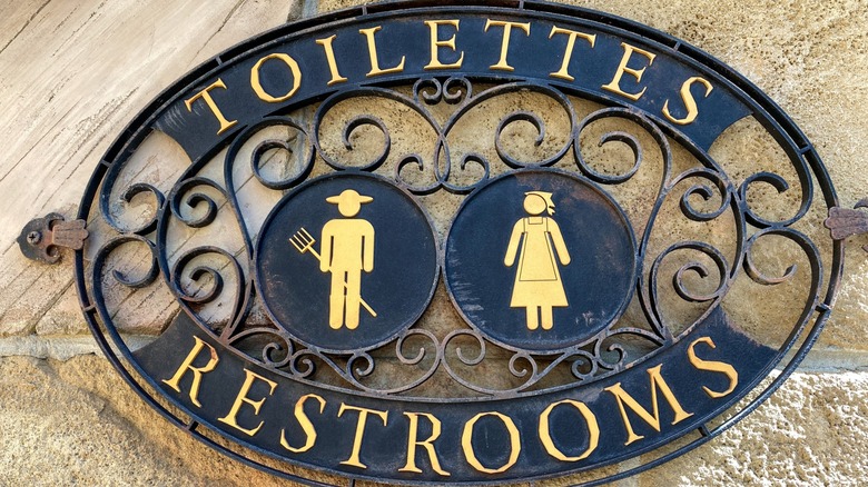A restroom sign at a theme park