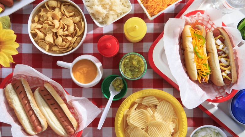 Hot dogs and food on a picnic table