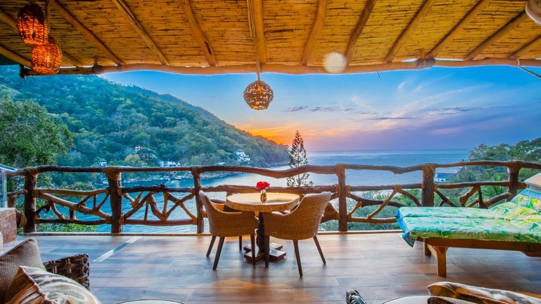Table and chairs on balcony overlook water and scenery