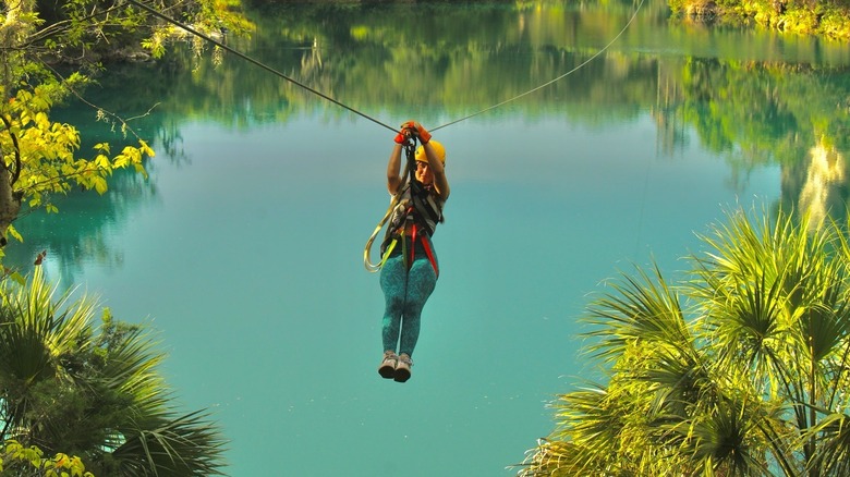 A person ziplining over water