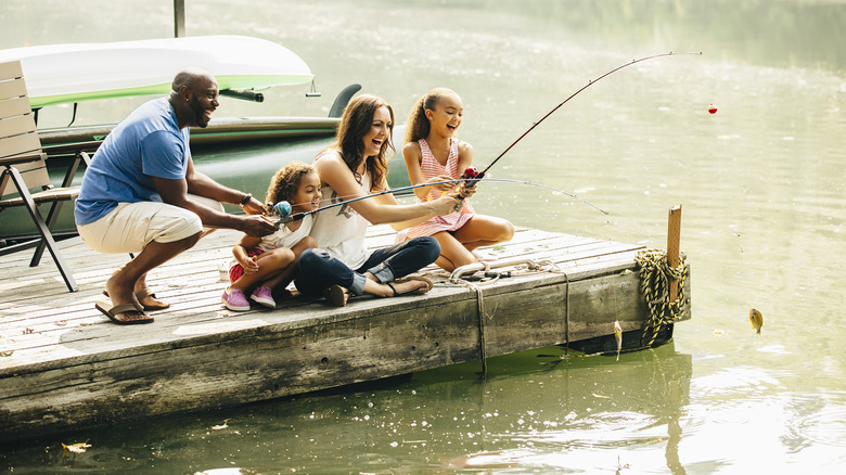 Family fishing on a wooden boat dock