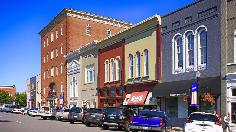parked cars lined up in front of stores