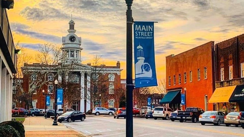 blue main street sign in parking lot