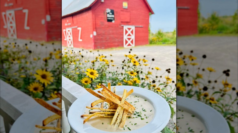 Bowl of soup in front of a red barn at 1844 House.