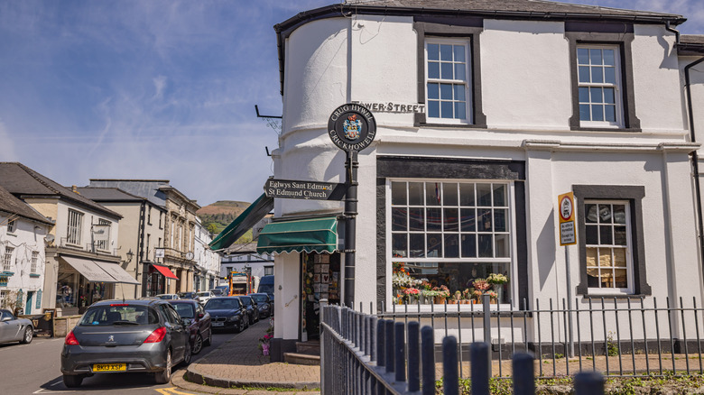 Local shops, cars, and Georgian architecture along Crickhowell's award-winning main street on a sunny day