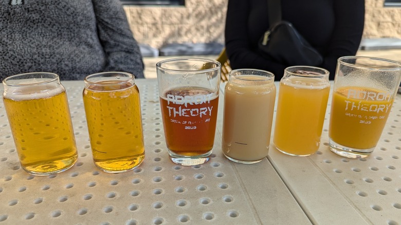 A selection of craft beer displayed on a table with a couple of branded glasses from Adroit Theory Brewing Company in Purcellville, Virginia