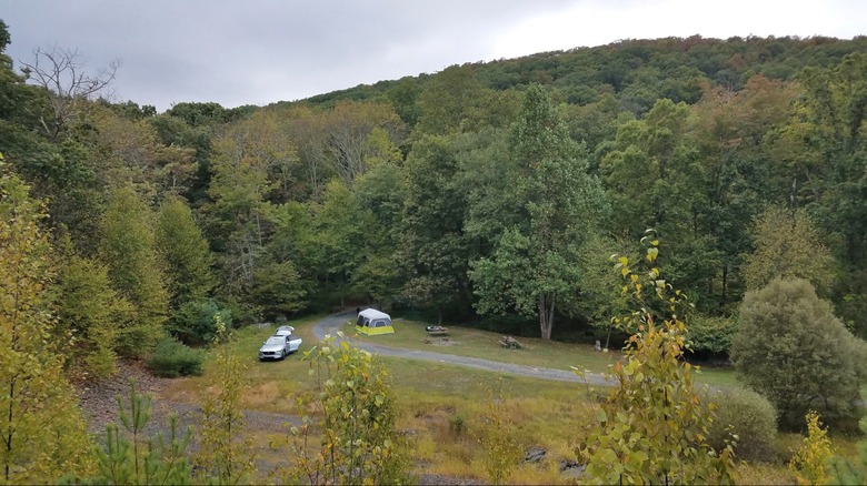View of Cranberry Run Campground in Pennsylvania, with a tent and a car