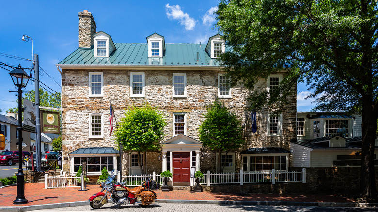 A hotel and tavern with brick siding and a chimney