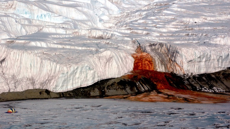 Two figures approaching Blood Falls