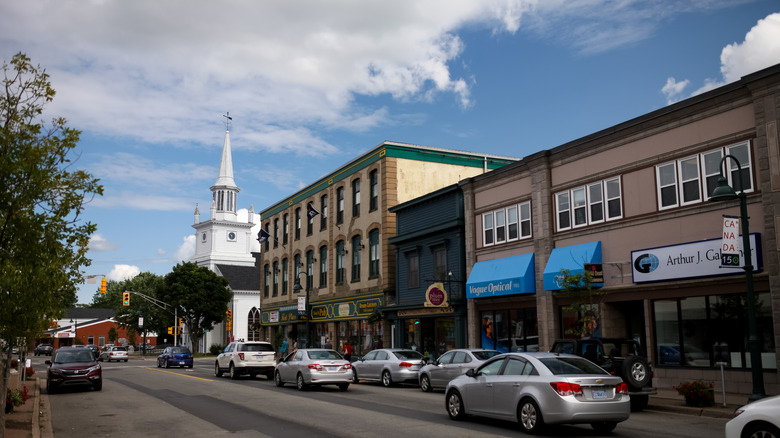 A bustling street lined with buildings on a cloudy day in Antigonish, NS