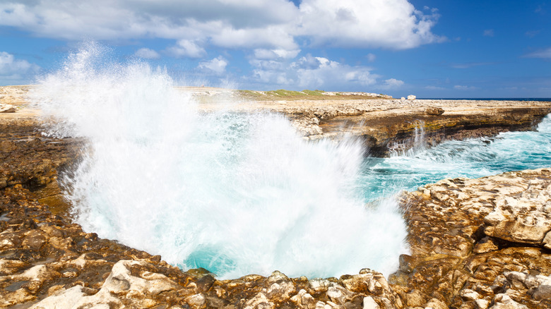 Waves crash against Devil's Bridge in Antigua
