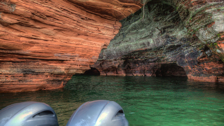Boat engines with Apostle Islands Sea Caves in the background