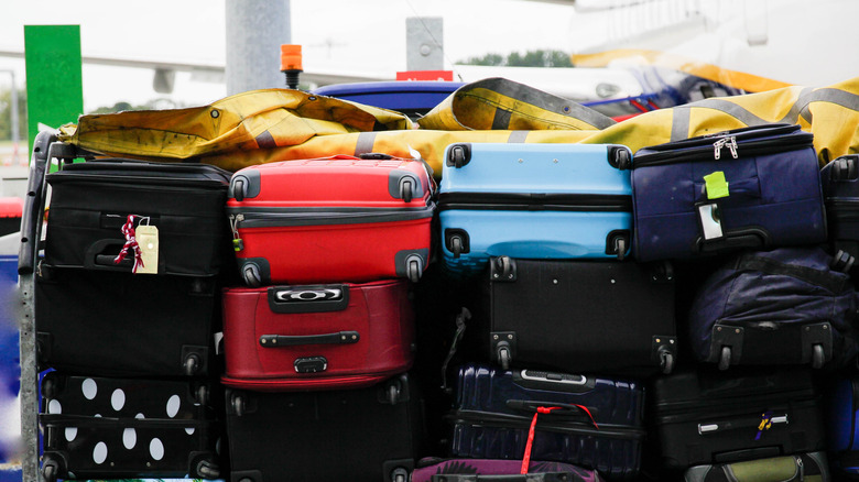 Stacked suitcases being transported in airport
