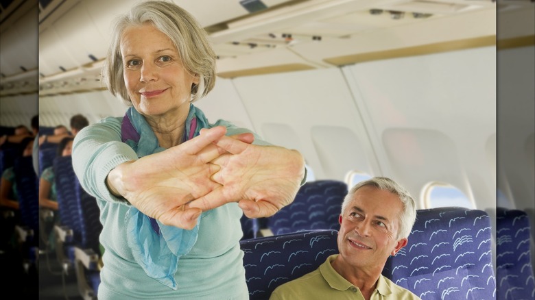 Woman stretching in aisle
