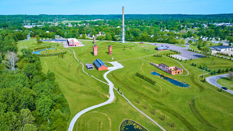 The Rastin Observation Tower and ruins surrounded by vibrant green space and trees in Ariel-Foundation Park in Central Ohio