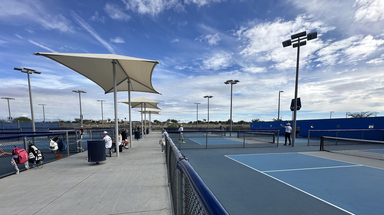 People playing tennis on the courts at Gilbert Regional Park in Arizona