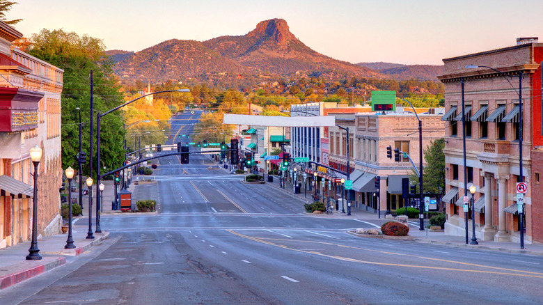 A downtown street in Prescott, Arizona, with a red rock mountain in the background