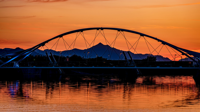 Footbridge across Tempe Town Lake in Tempe, Arizona, at dusk with sunset
