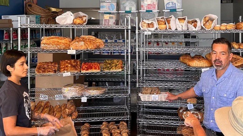 Barrio Bakery owner Don Guerra next to loaves of bread