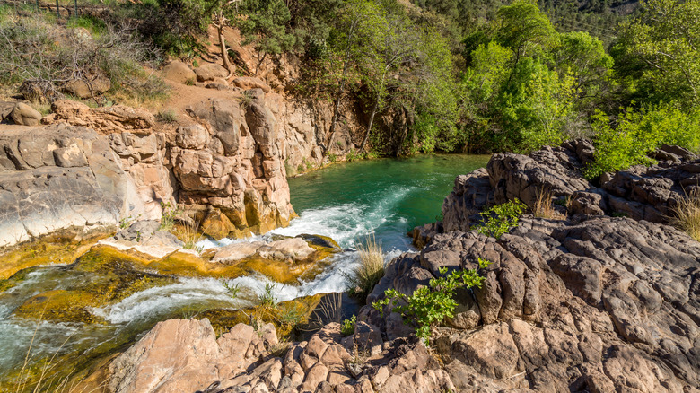 turquoise stream and pool in rocky canyon