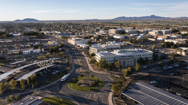 Aerial view of downtown Yuma with buildings and mountains in the distance.