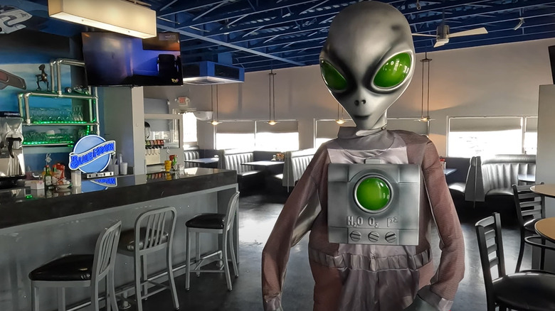 Space-Age diner interior and alien figure