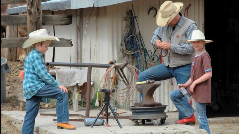 People wearing cowboy hats on a ranch