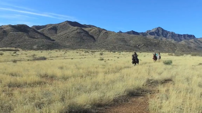 Horseback riding at Elkhorn Ranch surrounded by mountains