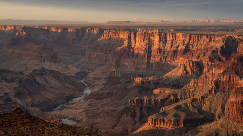The Grand Canyon at sunset with light illuminating the red and orange cliffs