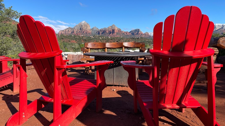Red chairs at a fire pit looking out at the red buttes