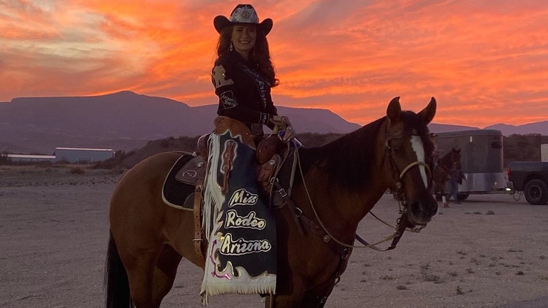 A woman on her horse at sunset