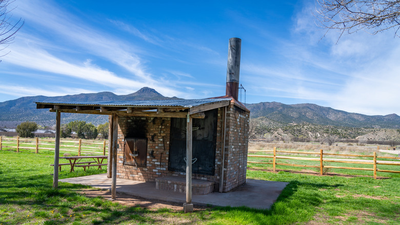 An old structure at Rockin' River Ranch State Park, Arizona, near the Verde River, with a mountainous backrop