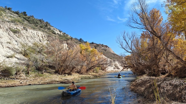 Two kayakers paddling on the Verde River at Rockin' River Ranch State Park, Arizona