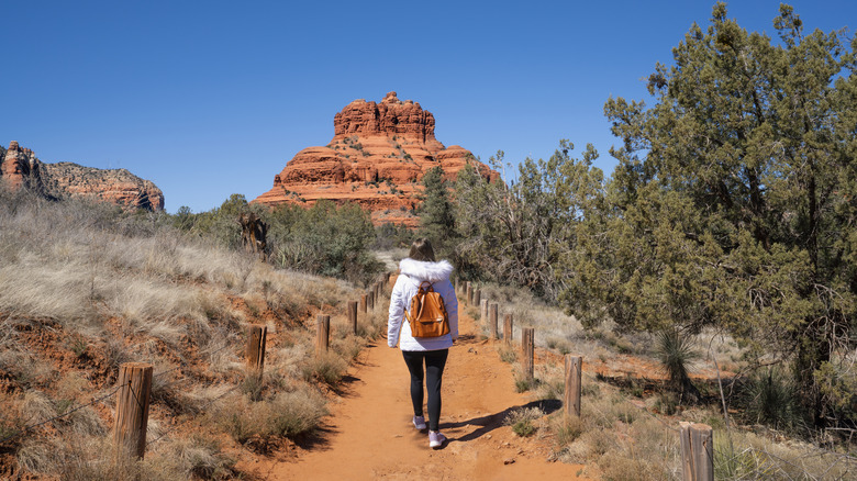 Woman walking on pathway on Bell Rock Loop near Sedona, Arizona