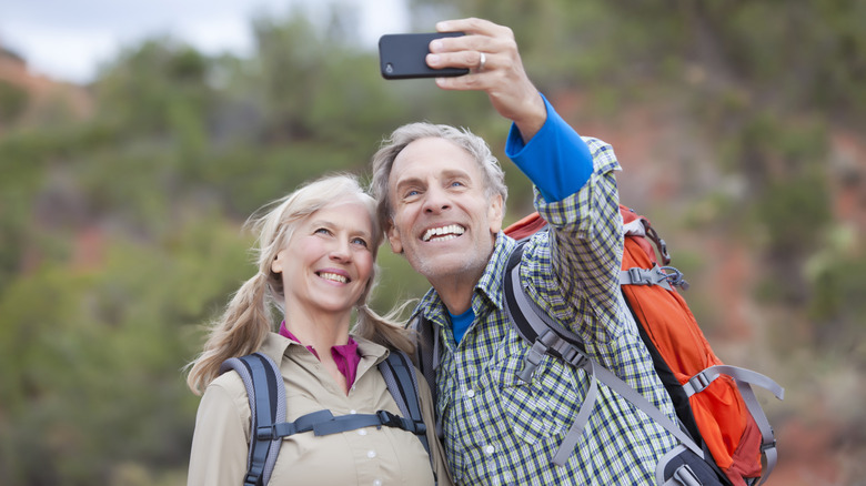 Old man and woman taking selfie smiling