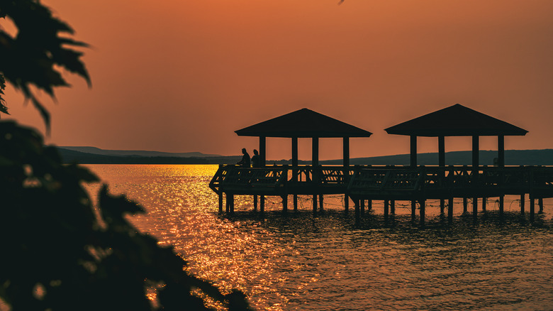 People on fishing pier watching stunning sunset at Lake Dardanelle