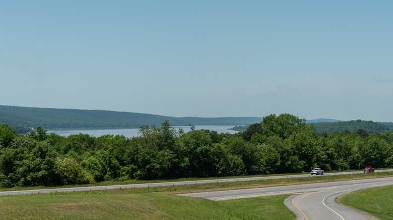 Vehicles traveling on highway with Lake Dardanelle in the background