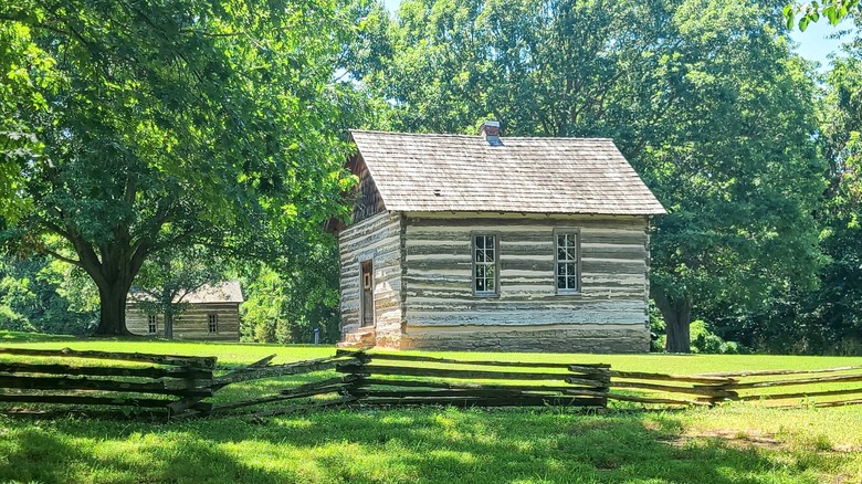 A log cabin surrounded by trees in Prairie Grove Battlefield State Park, Arkansas