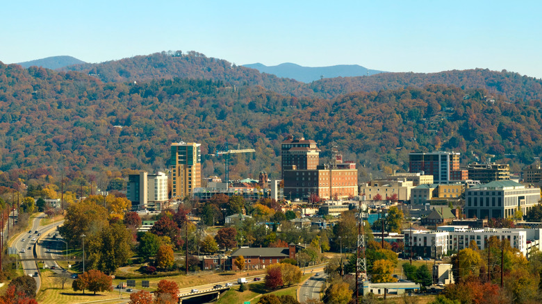 Asheville city skyline surrounded by forested mountains in fall