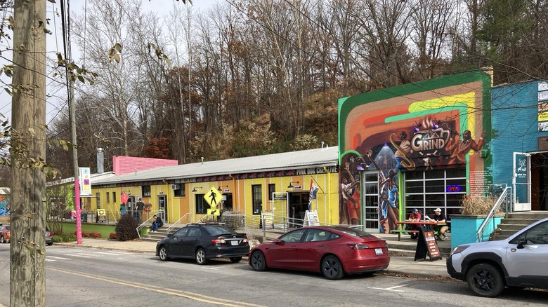 A block of colorful buildings lining the street in Asheville, North Carolina's River Arts District