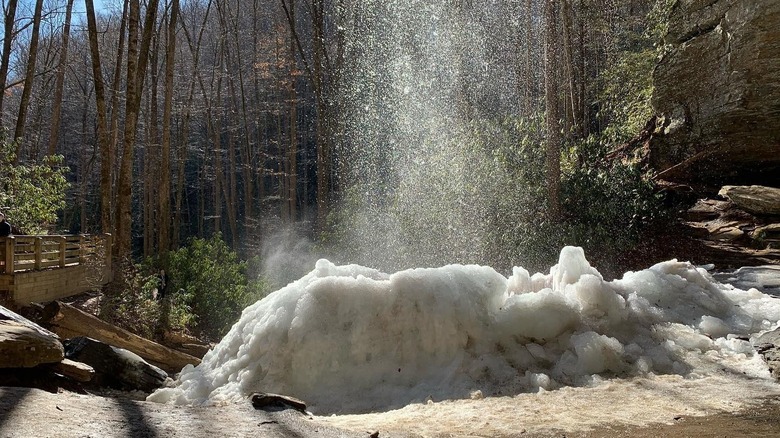 Water cascading into an ice pile at Moore Cove Falls, North Carolina